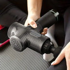 FODRK massage gun being used on a leg during a fitness routine